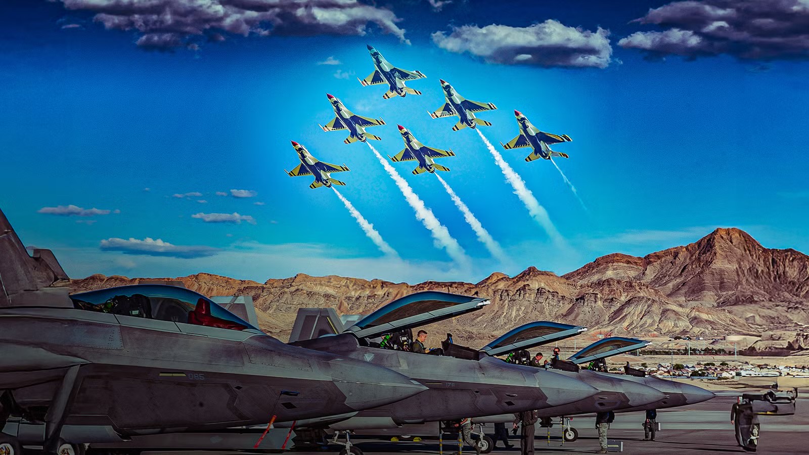Military aircraft arranged on an air base flight line beneath a formation of jets flying overhead